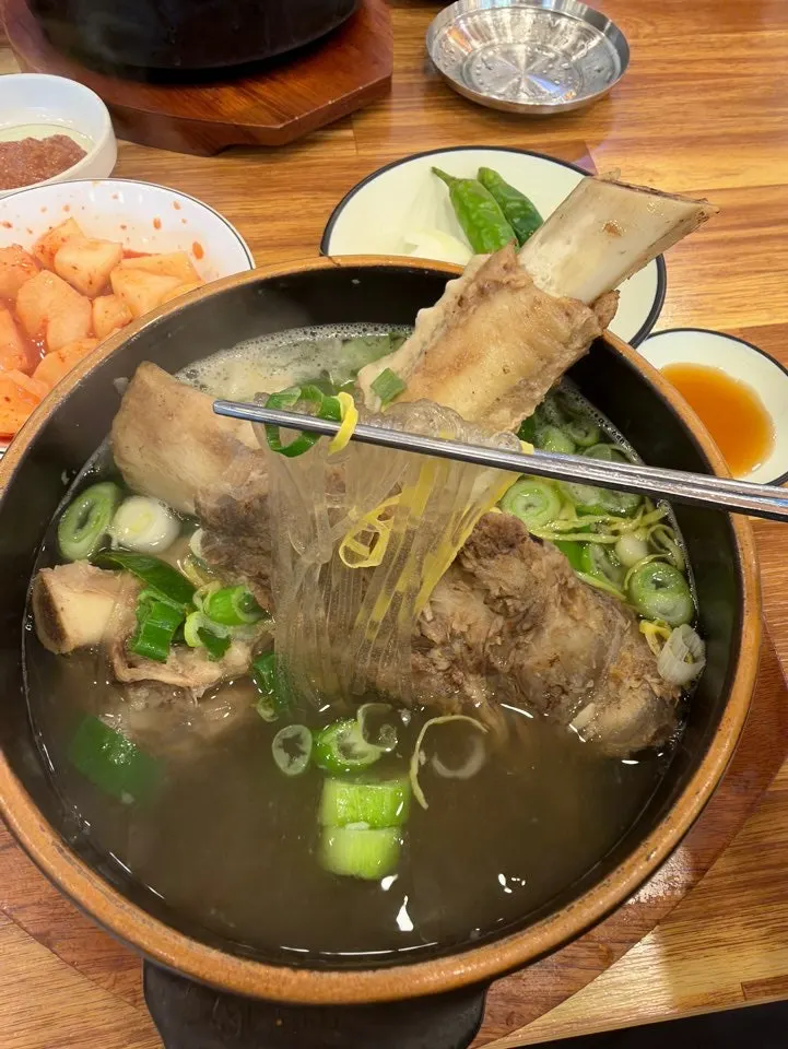 Lifting a large rib bone out of the broth