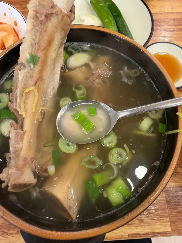 Inside the galbitang showing glass noodles, scallions, and egg garnish