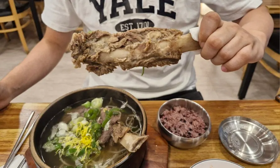 A large rib held up by hand