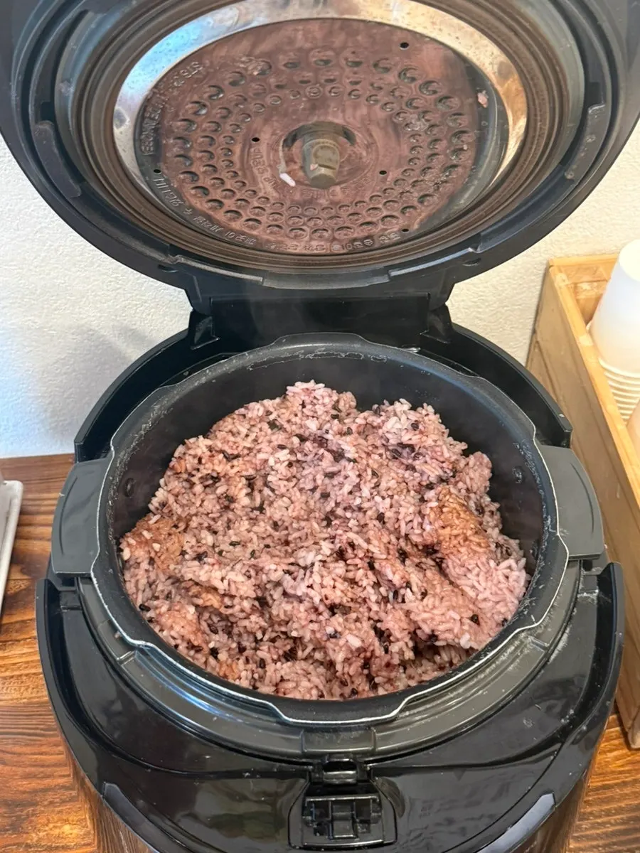 Self-serve corner with unlimited rice refill sign