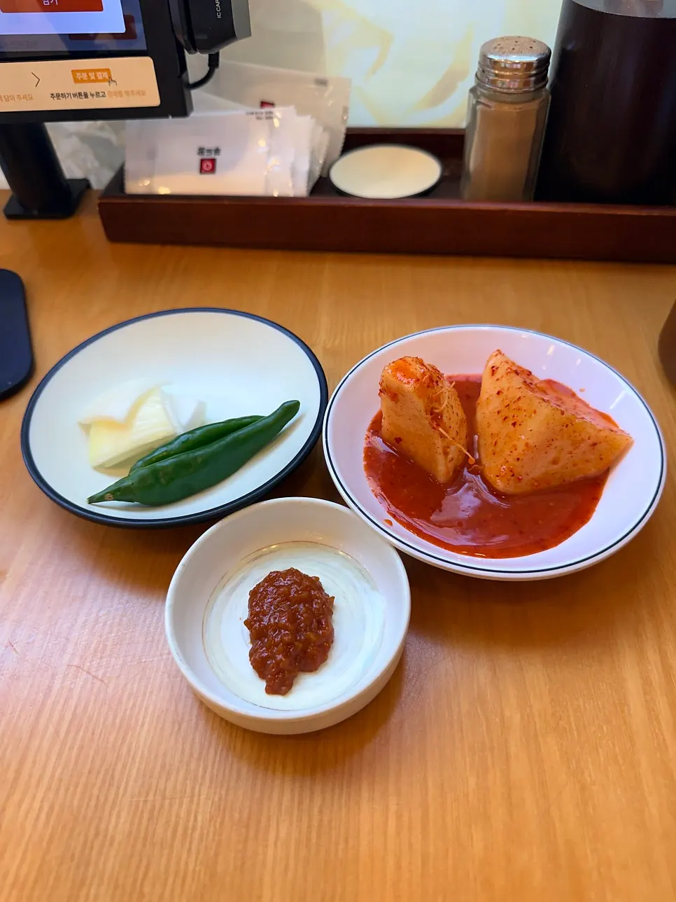 A piece of meat topped with kimchi