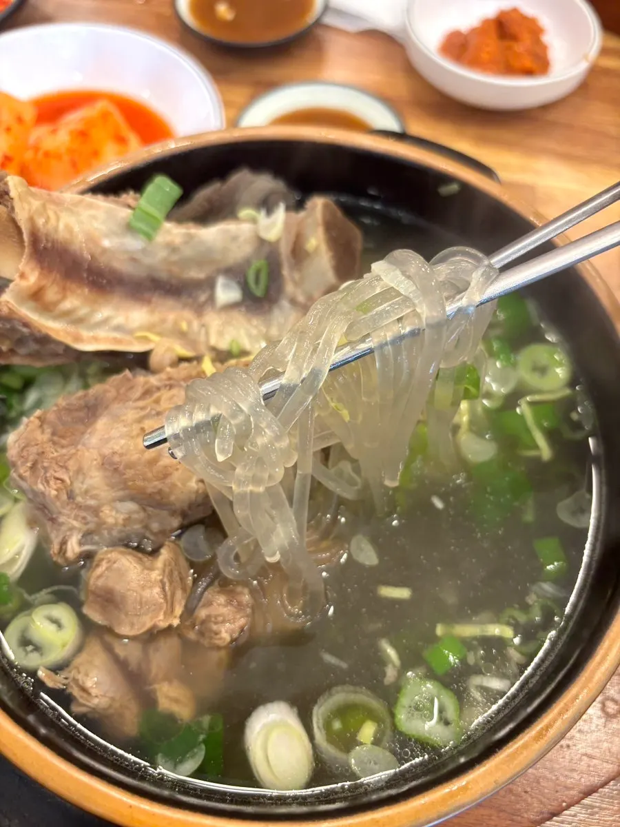 Galbitang topped with plenty of scallion and egg garnish