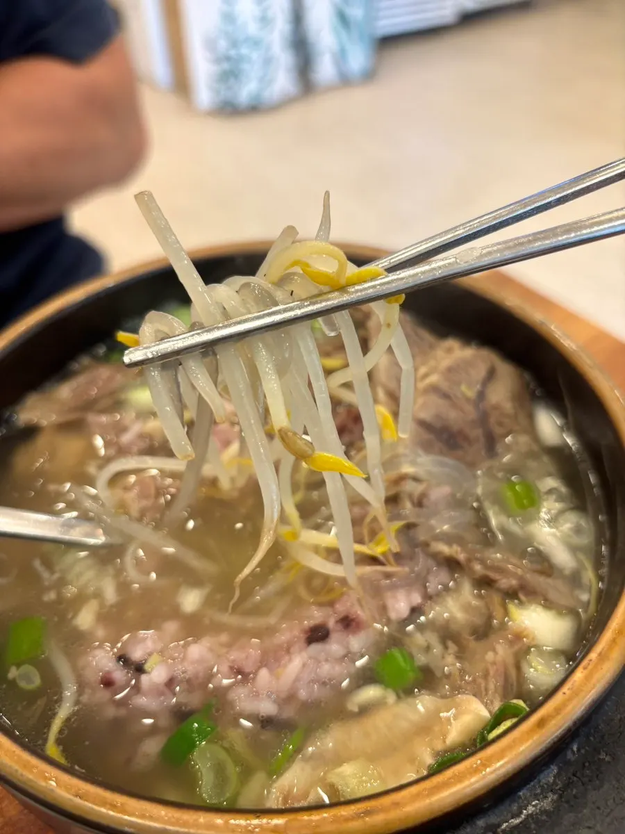 Glass noodles and bean sprouts lifted out of the galbitang