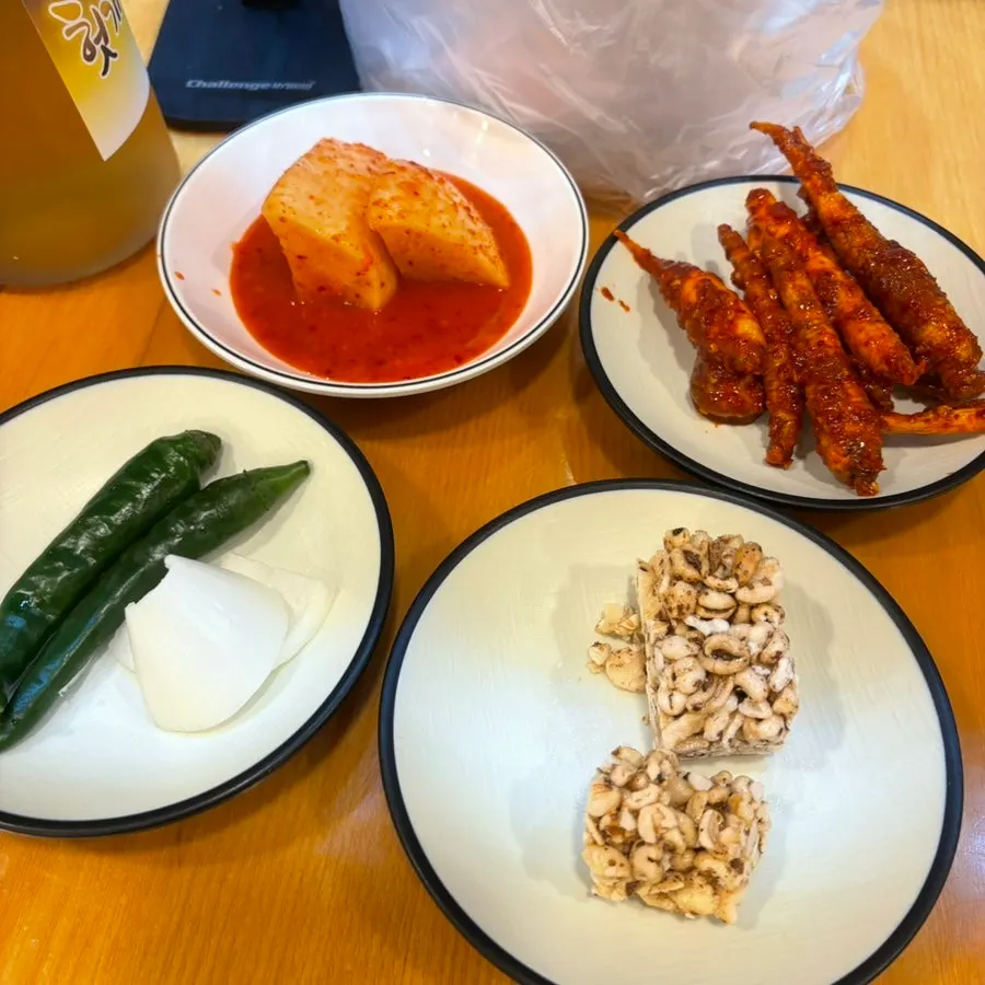 Three side dishes: seokbakji, baechu kimchi, and doraji muchim