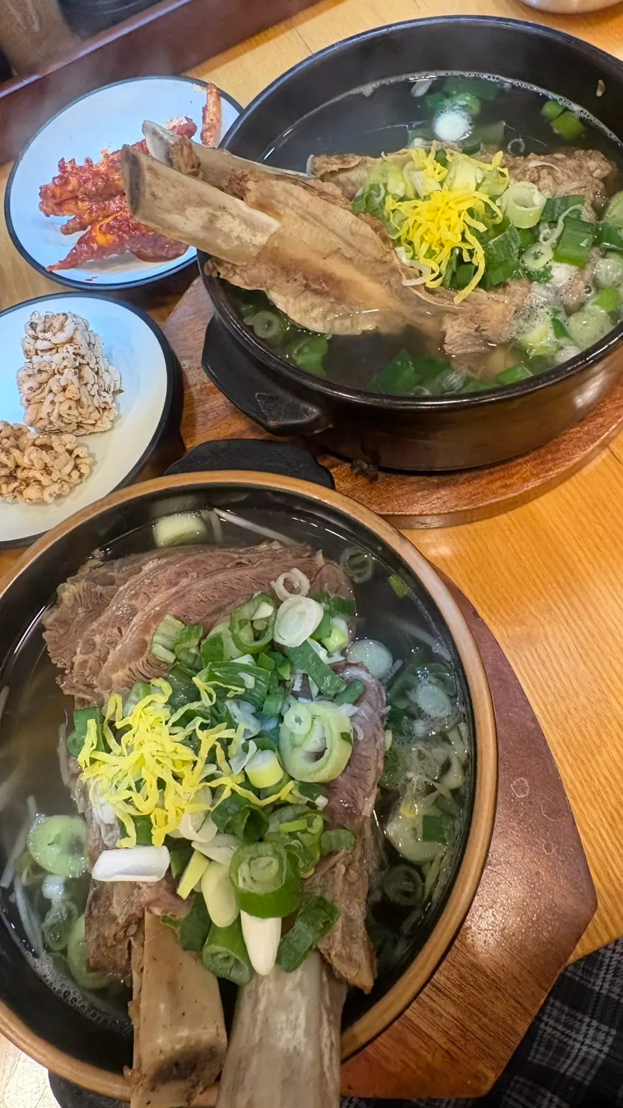 A bowl of rice soaked in broth topped with seokbakji
