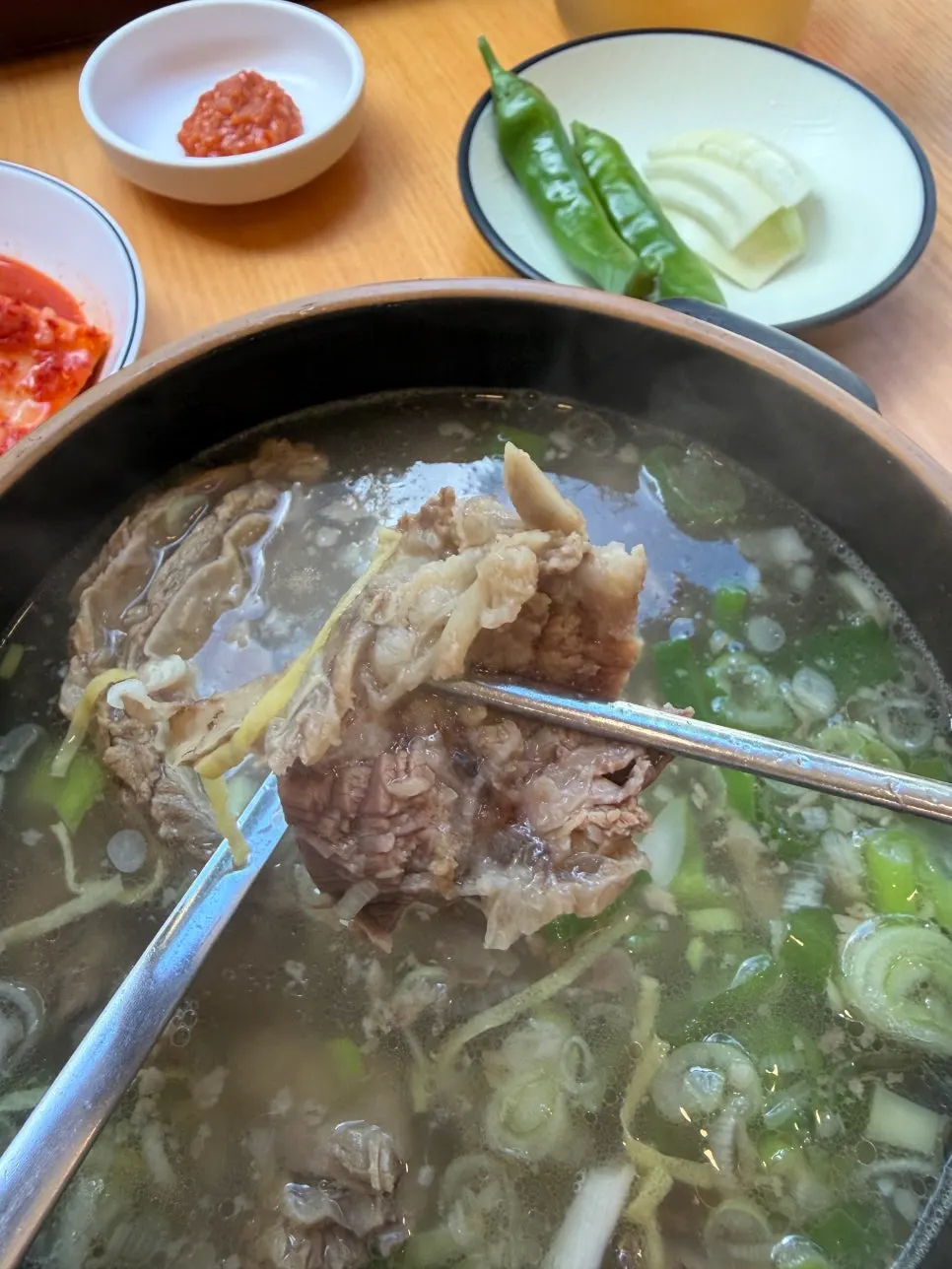 A spoonful of galbitang rice topped with kkakdugi