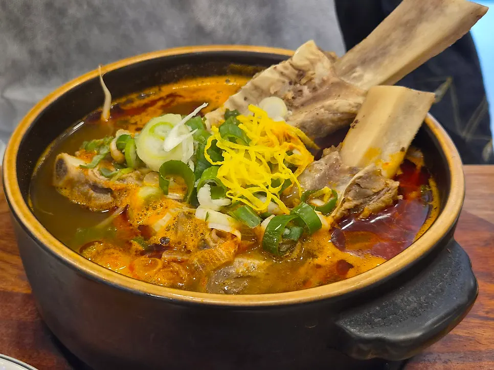 A bowl of spicy galbitang with red broth