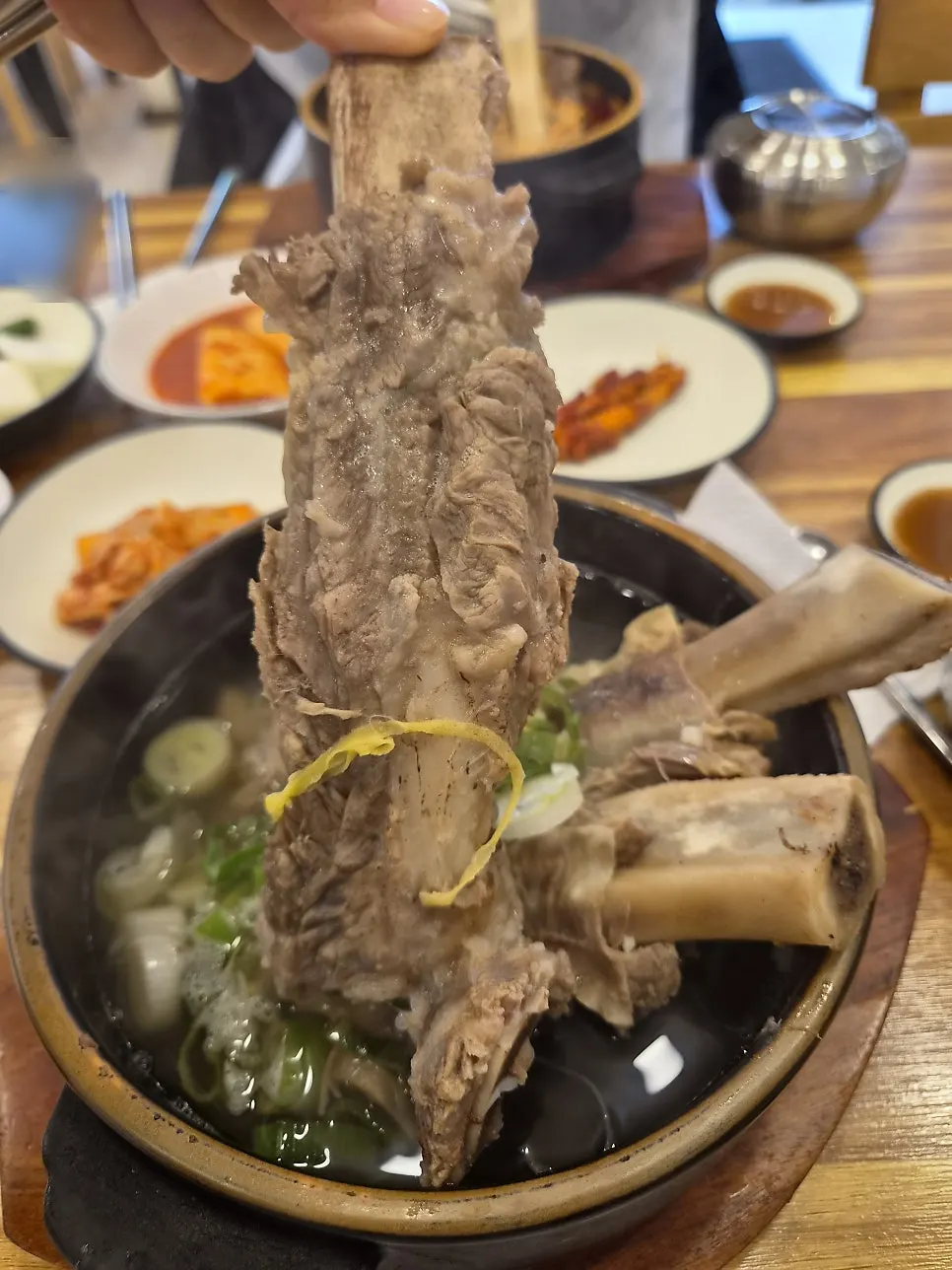 Comparing the size of the wang galbi rib bones lifted out of the soup