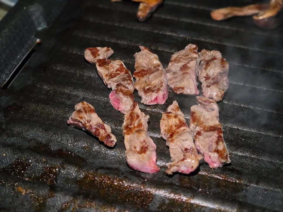Hanwoo grilling spread set up at an outdoor table