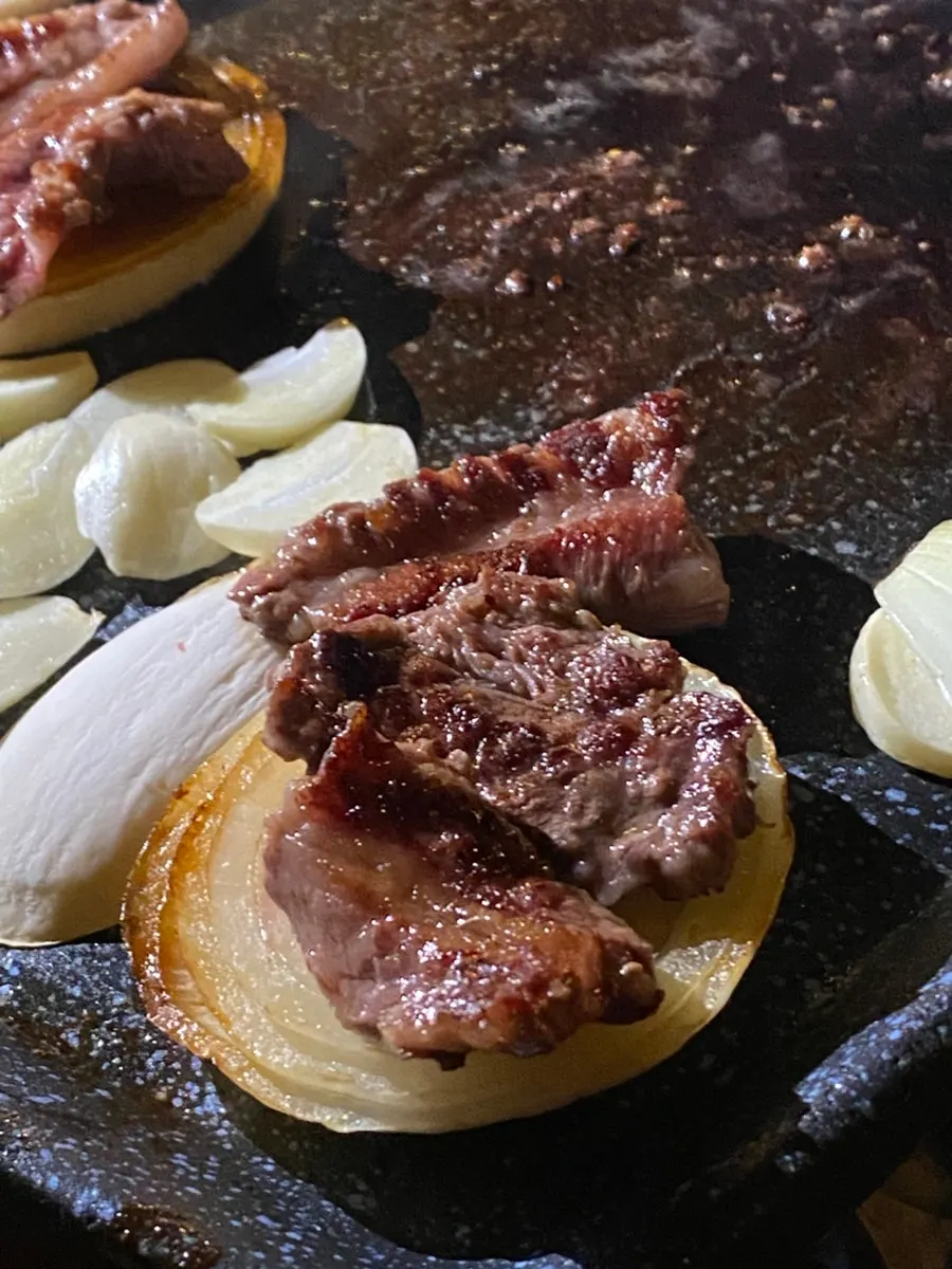 Onion and potato grilled alongside the beef