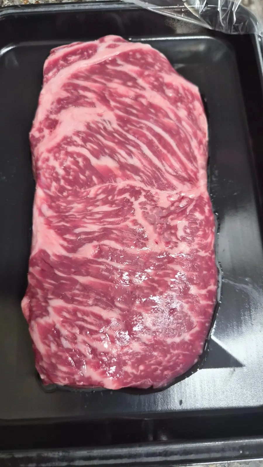 Striploin sizzling on the grill pan
