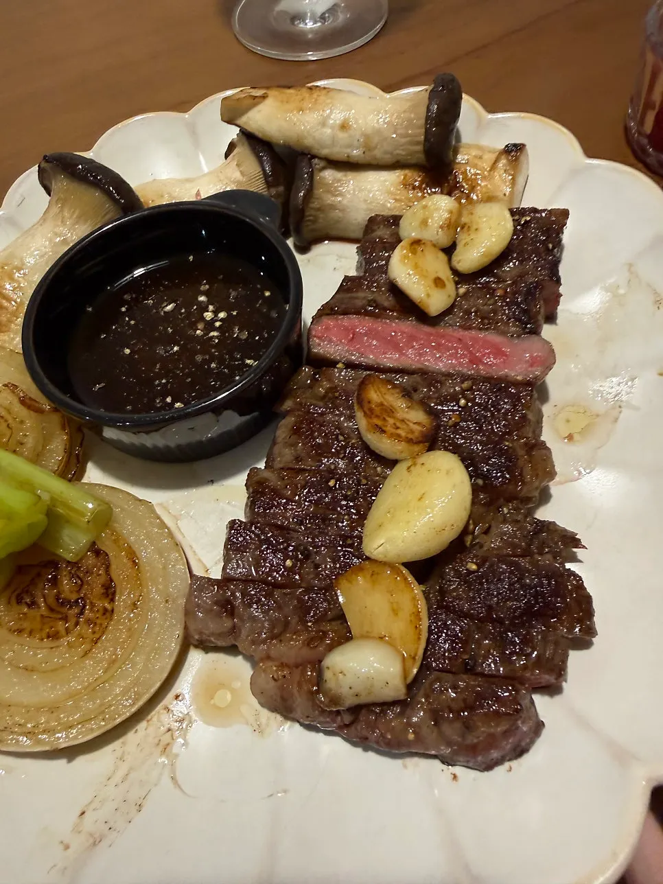 Steak plated with grilled vegetables on the side