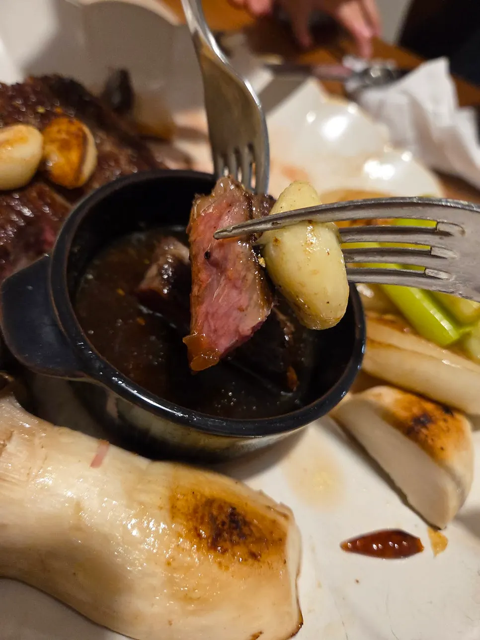 A slice of hanwoo striploin dipped in sauce