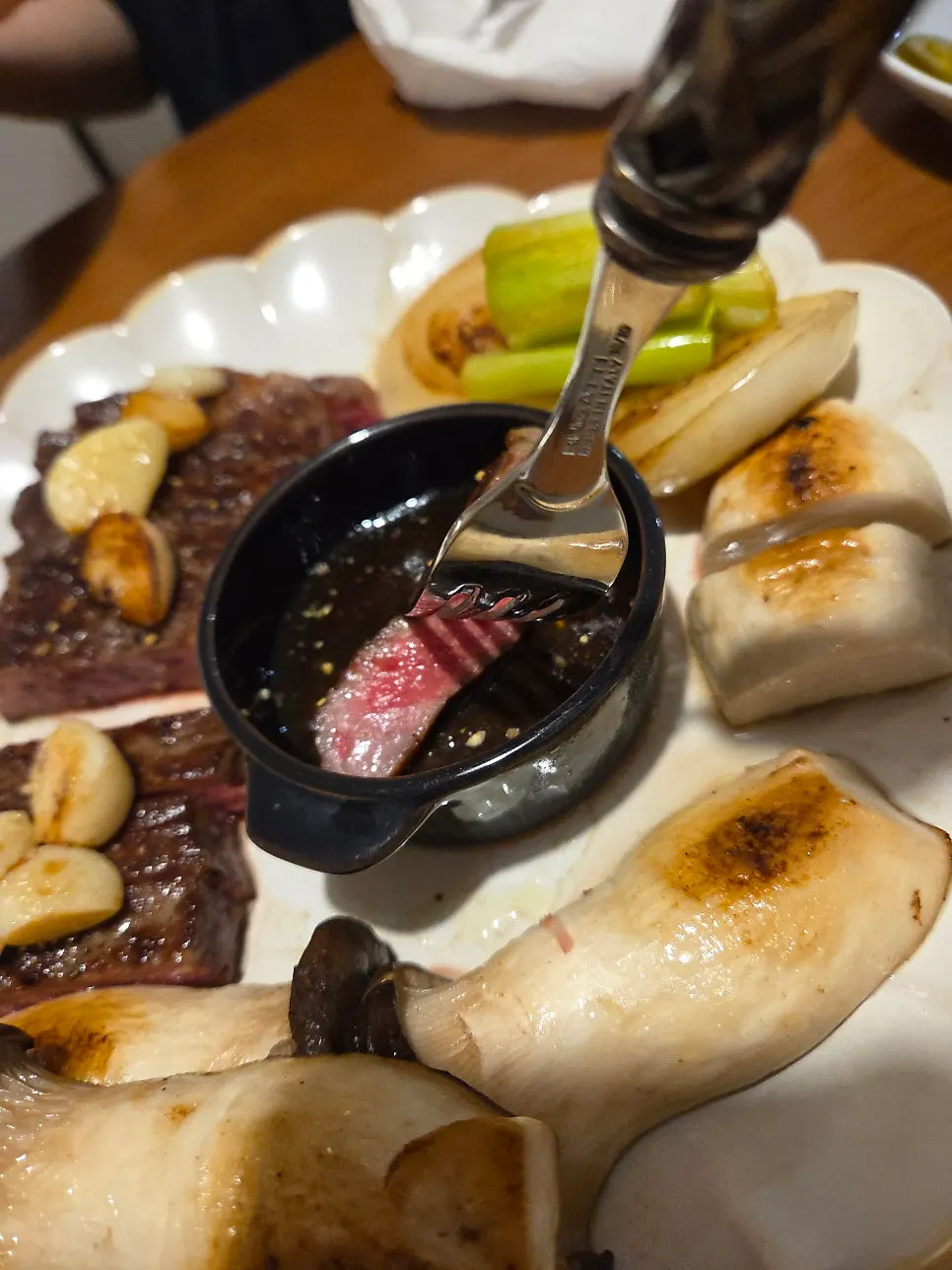 Hanwoo steak eaten together with roasted whole garlic