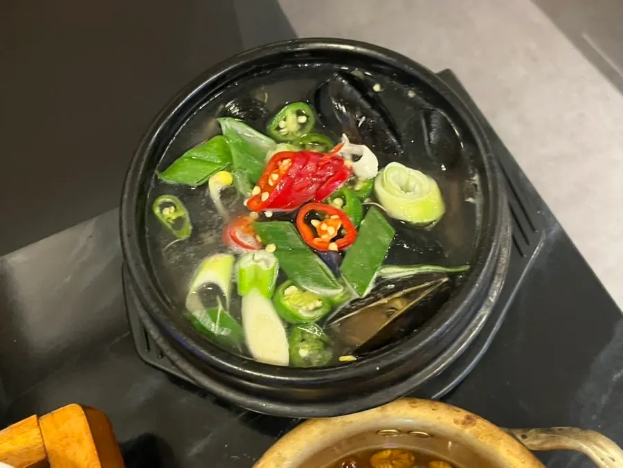 Basic banchan with silkworm pupa soup and jeon pancakes