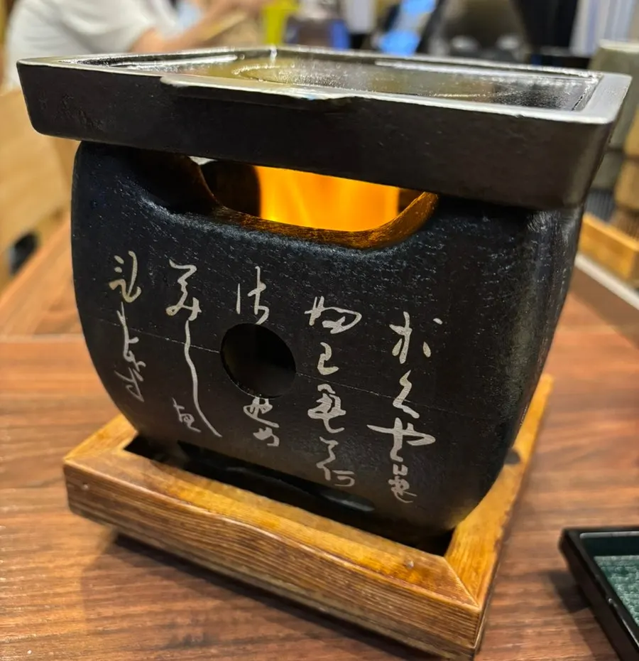 Table setting of gyukatsu sides including takana and tare sauce