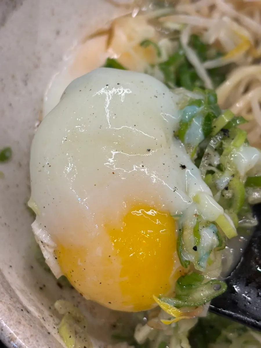 Chashu ramen broth with the soft-boiled egg popped open
