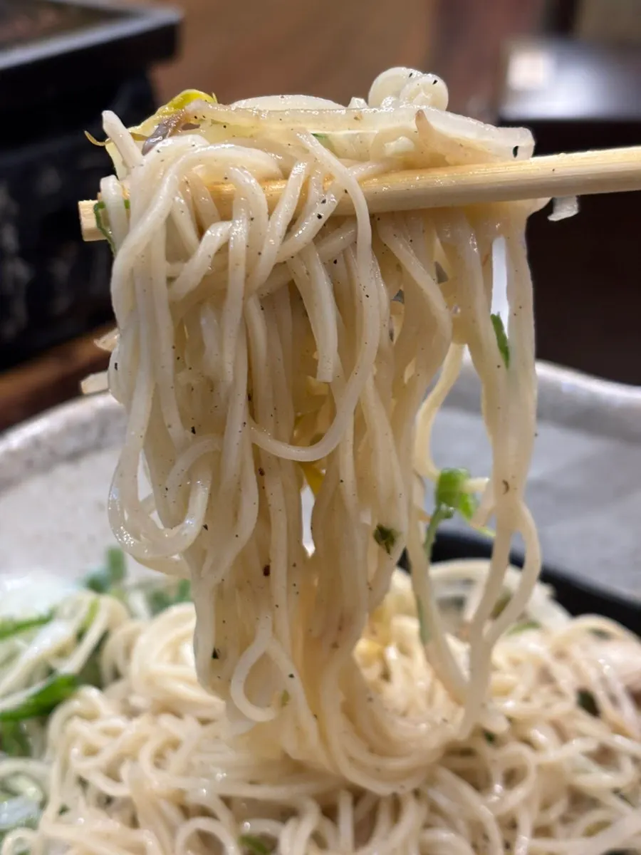 Bouncy ramen noodles lifted with chopsticks