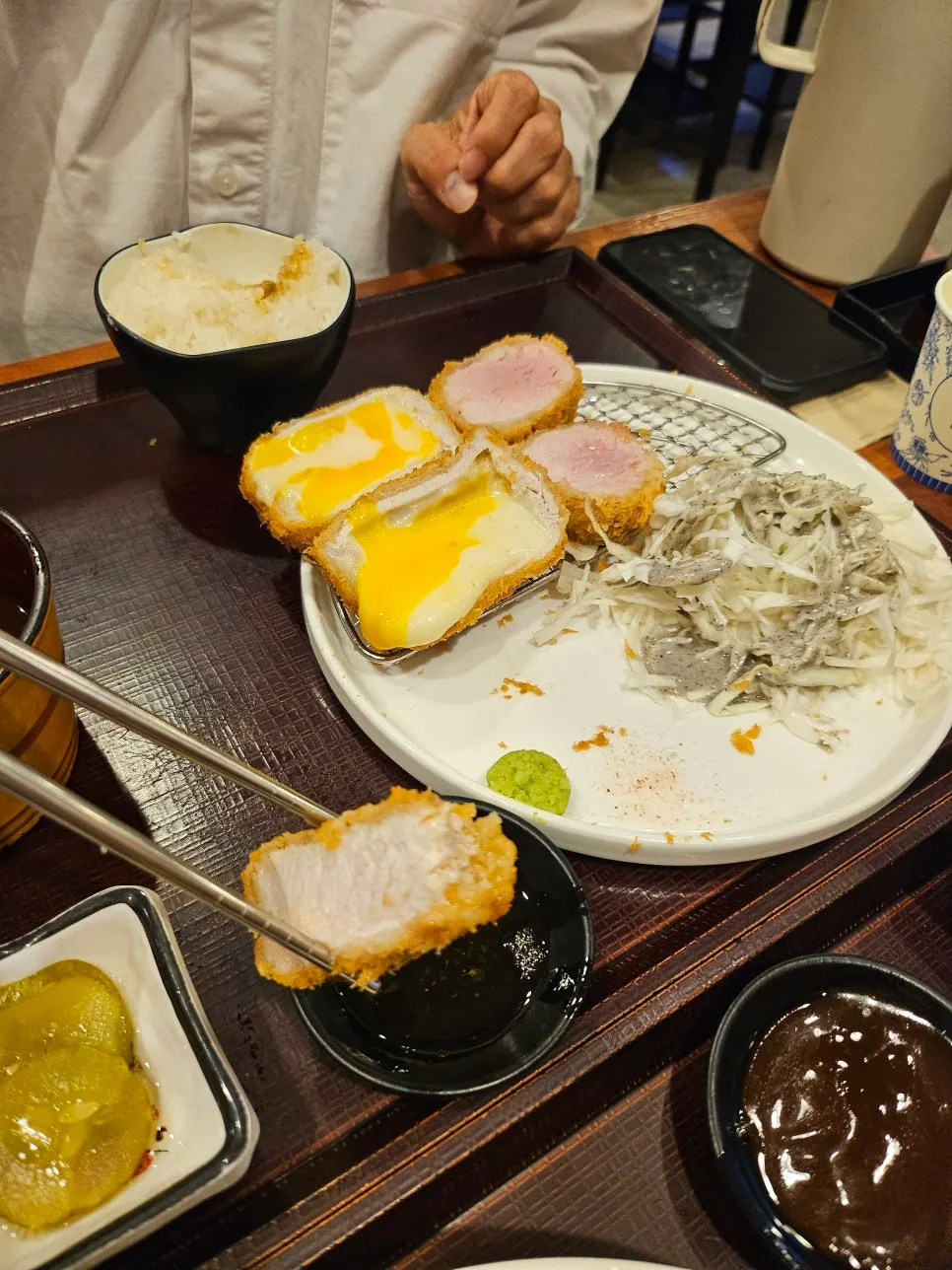 A piece of cutlet served with salt and wasabi