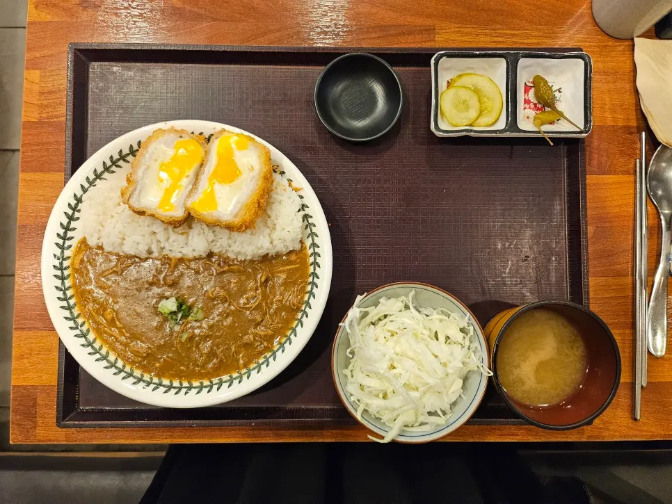 A plate with cheese katsu and curry together