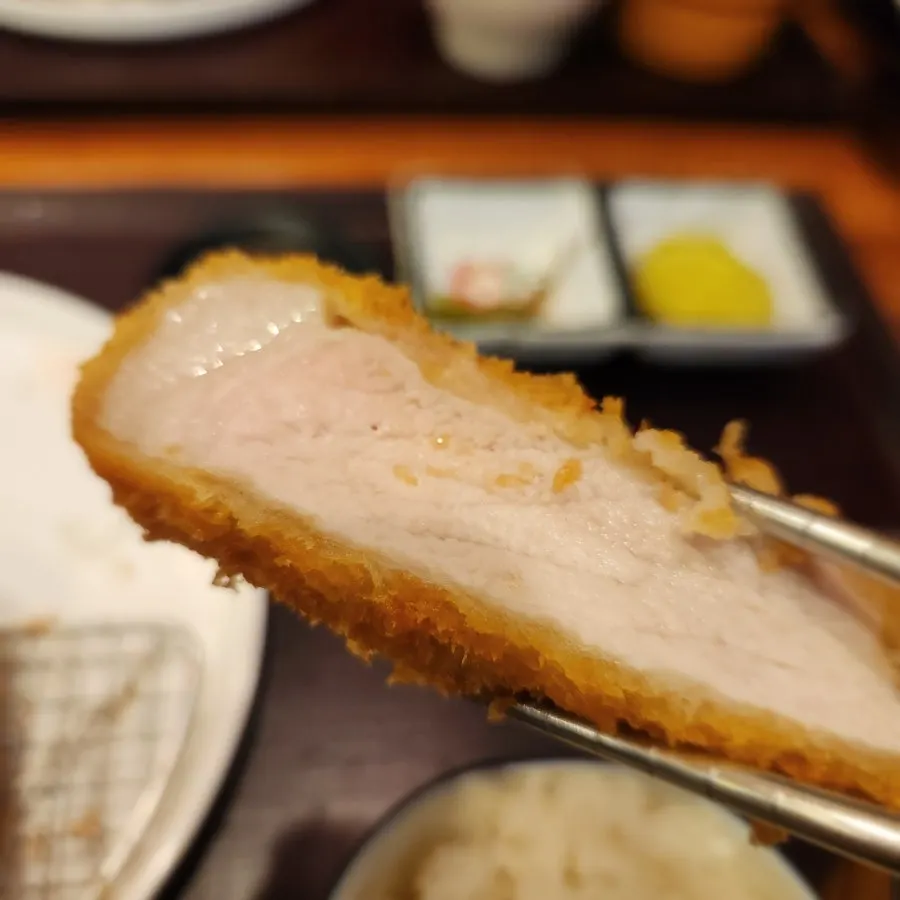 Picking up a piece of loin katsu