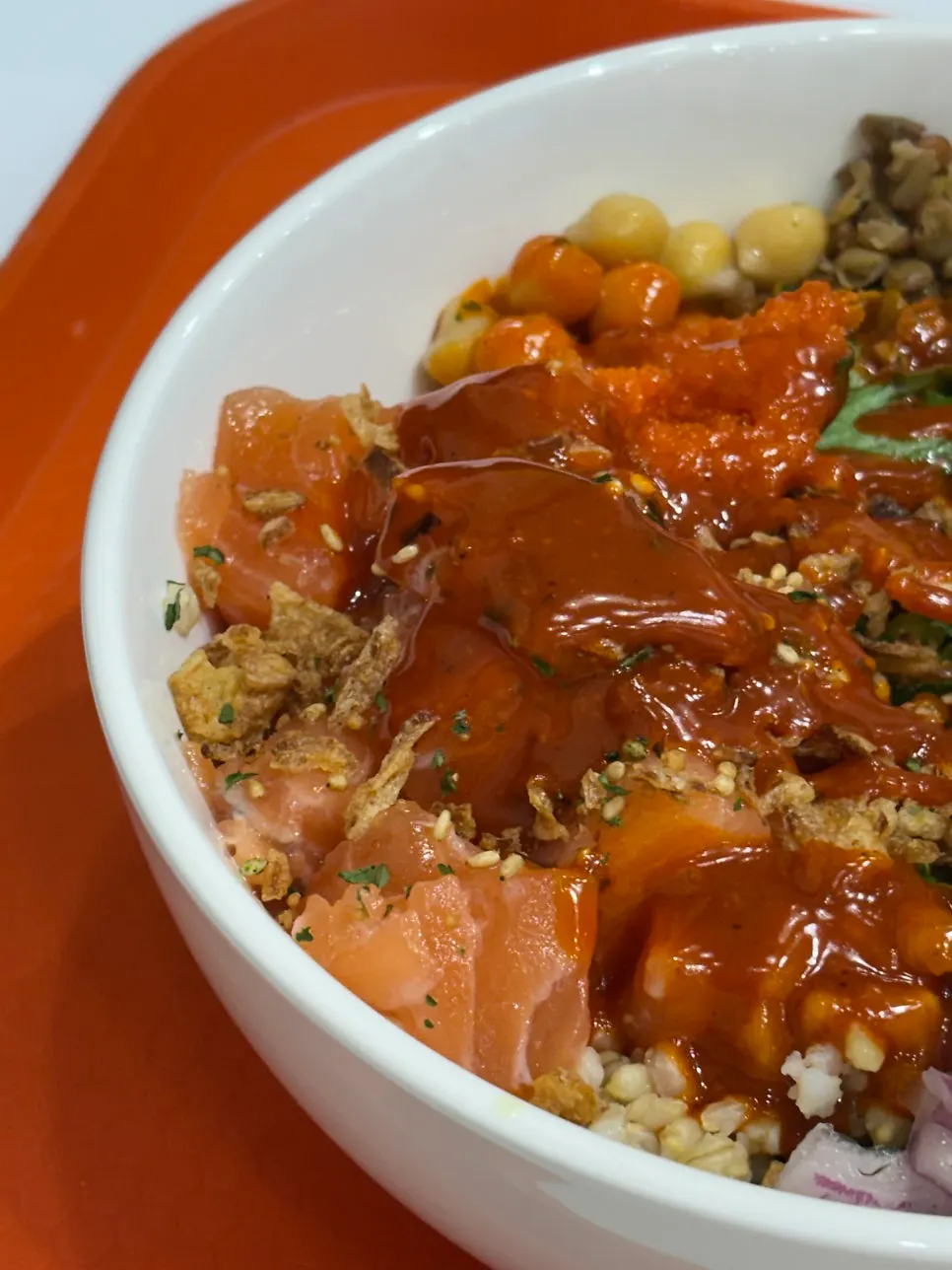 Poke bowl topped with thick-cut raw salmon