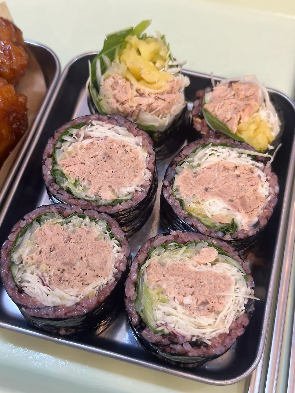 A roll of tuna gimbap with plenty of cabbage inside
