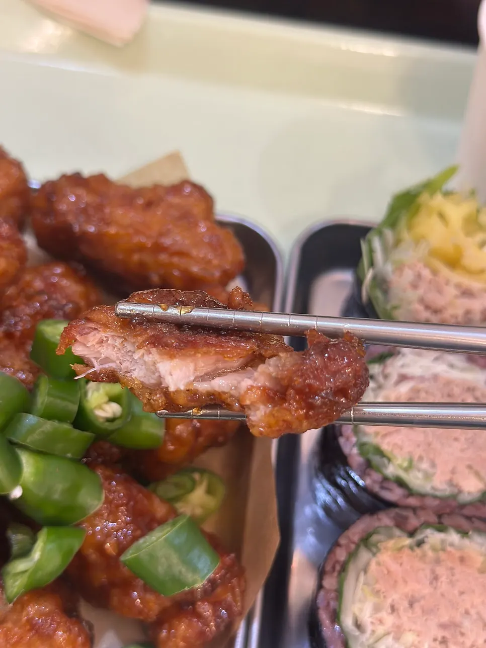 Close-up of crispy dakgangjeong topped with pepper