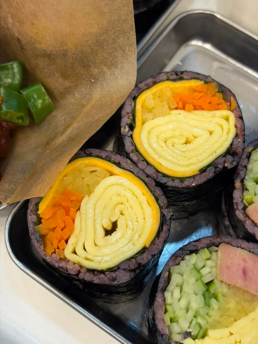 Cross-section of double cheese gimbap with melted cheese