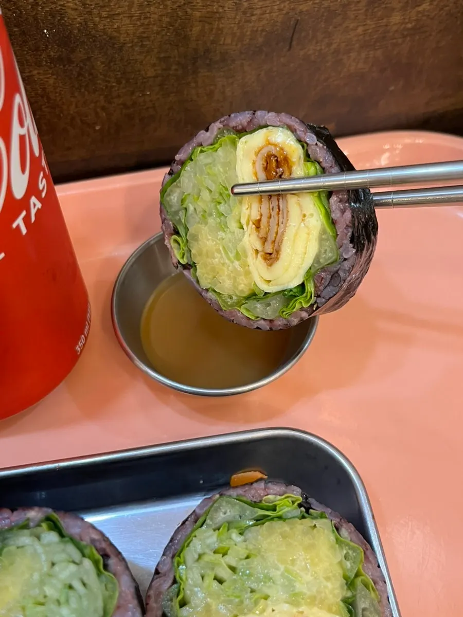 Black rice gimbap dipped in wasabi sauce