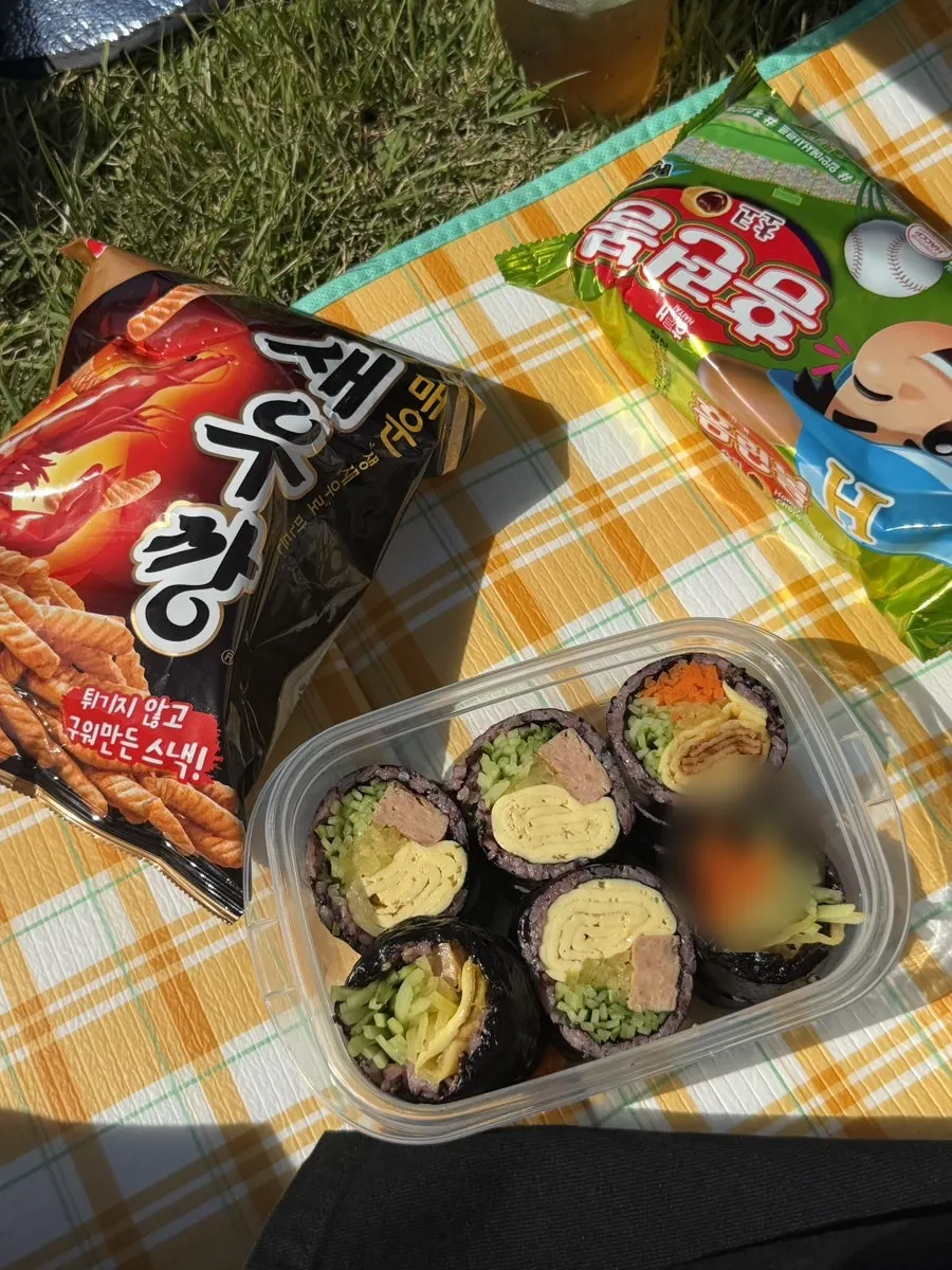 Full spread of gimbap, dakgangjeong, and cup noodle