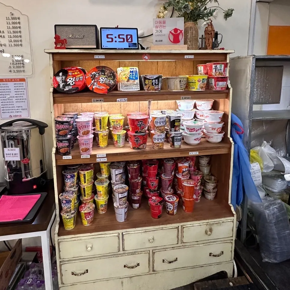 Variety of cup noodles displayed at Halls Gimbap