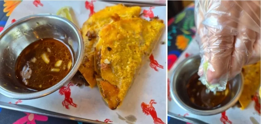 Two pieces of birria taco with sauce