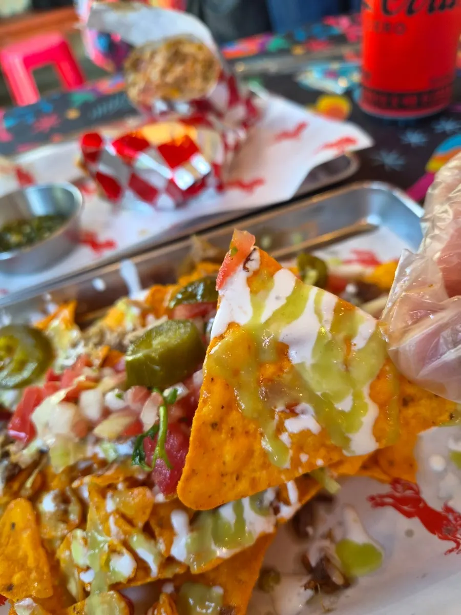 Eating chili nachos with disposable gloves on