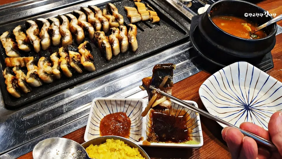 A piece of salt-grilled eel topped with shredded ginger