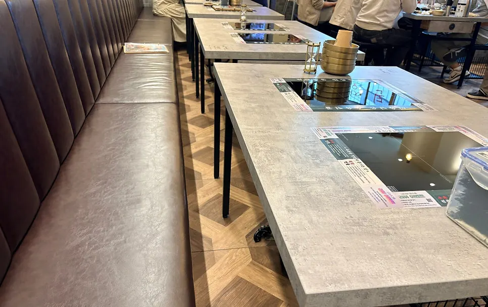 Interior of Ok Doenjang with sofa seats that have backrests