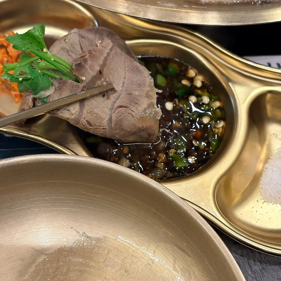 A piece of boiled pork pulled from the hot pot