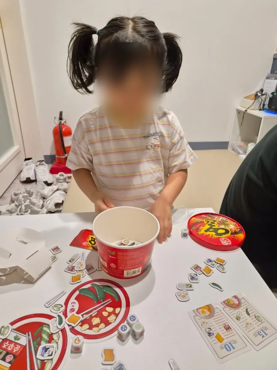 26-month-old playing with the game pieces