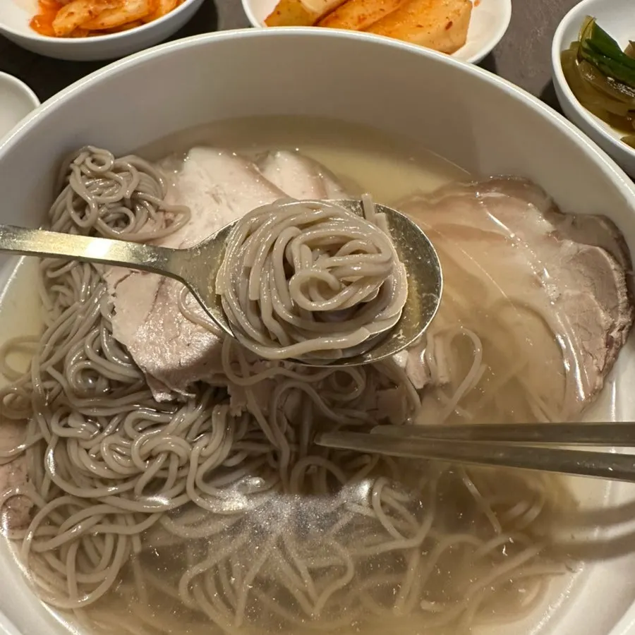A bowl of Pyongyang naengmyeon with generous noodles and meat