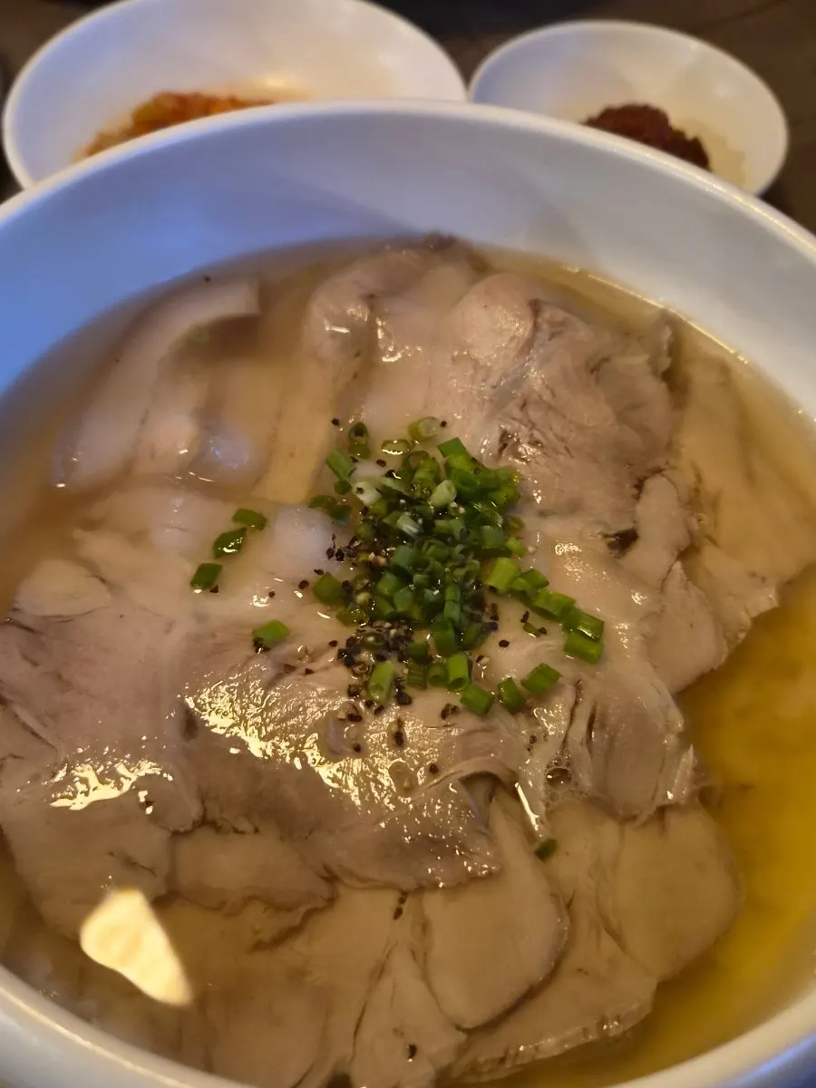 Clear pork gomtang broth and pork at Anok