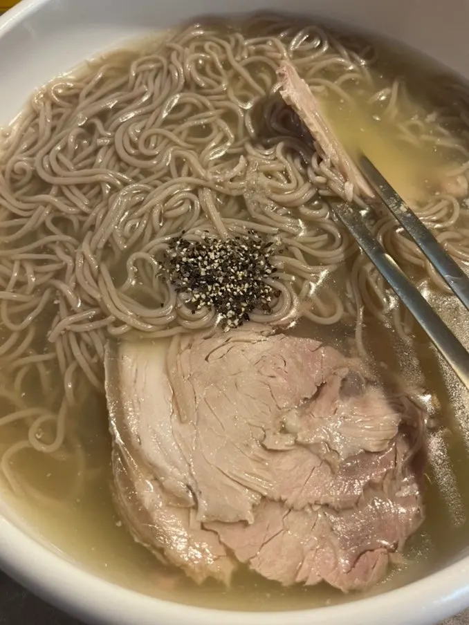 Lifting a strand of Pyongyang naengmyeon noodles