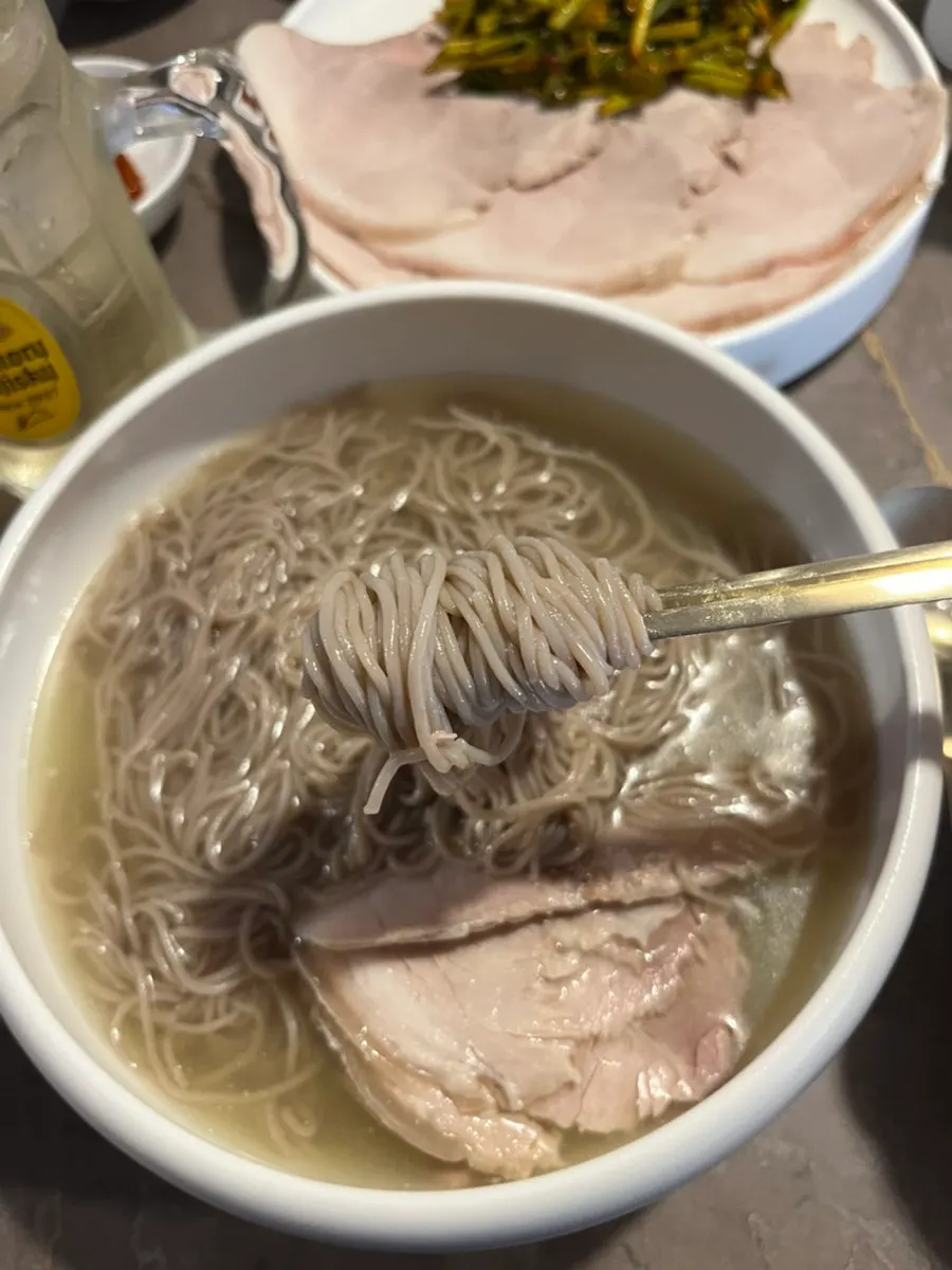Table with Pyongyang naengmyeon and cold pork