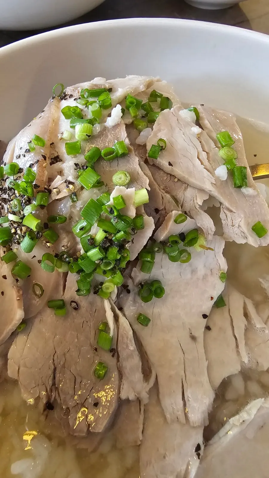 Meat clinging to the bone in the pork tail jjim