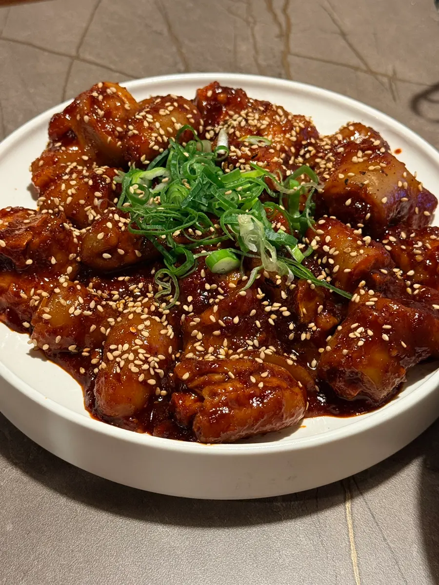 Anok's pork tail jjim topped with sesame seeds and scallions