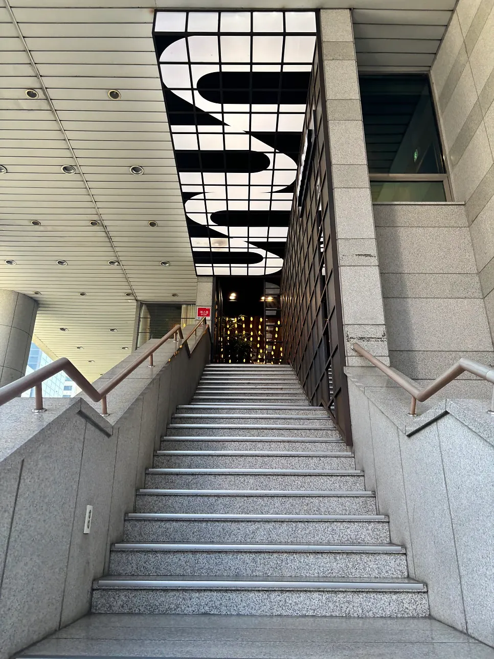 Entrance stairs leading up to Juno Hair near Hongdae Station