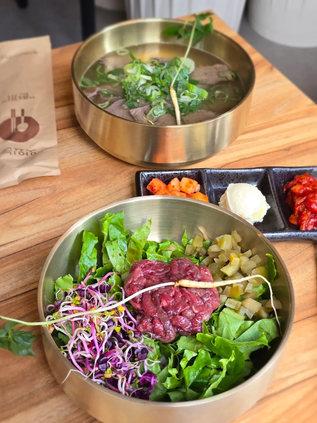 Lunch spread of beef gomtang and soy yukhoe bibimbap at Baengni Gomtang