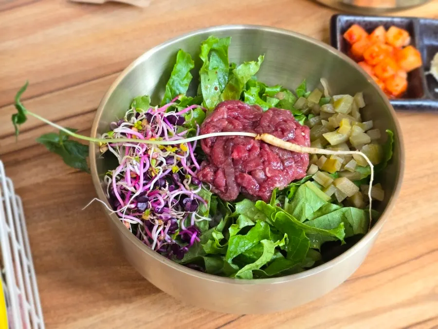 A bowl of soy-marinated beef yukhoe bibimbap