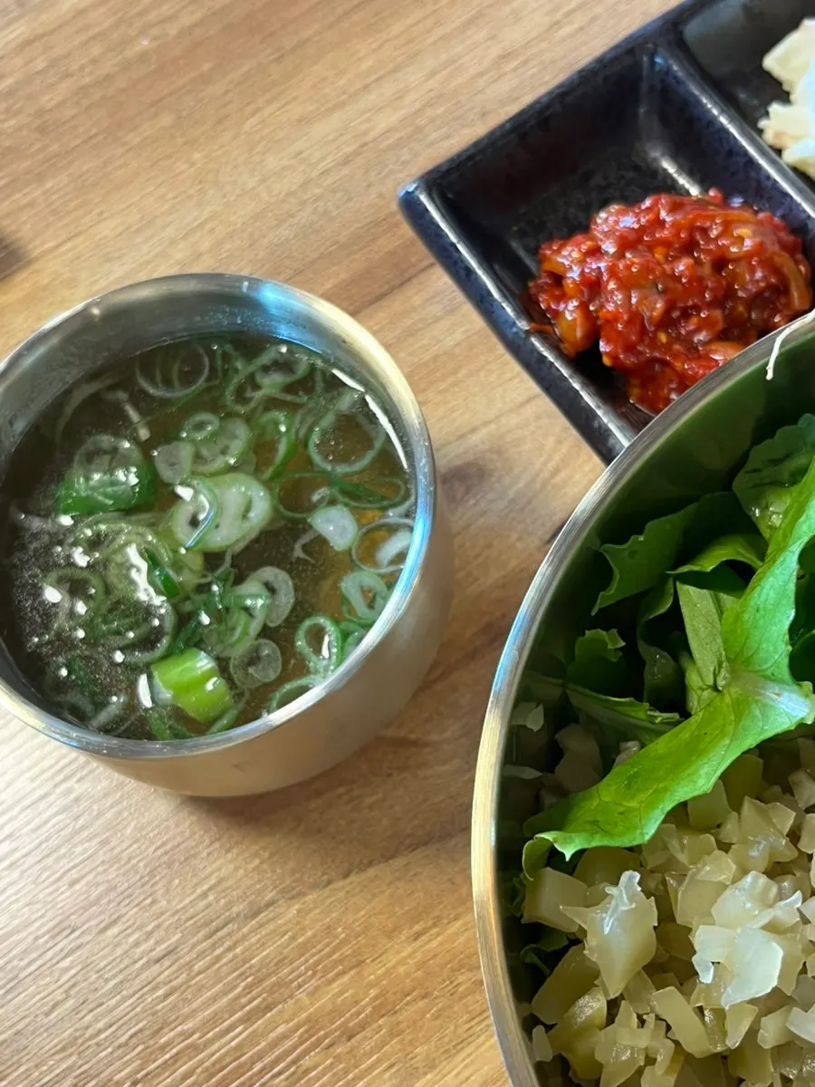 A bowl of clear gomtang served alongside the meal