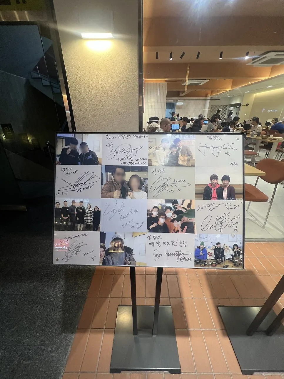 Board covered with celebrity signatures and photos