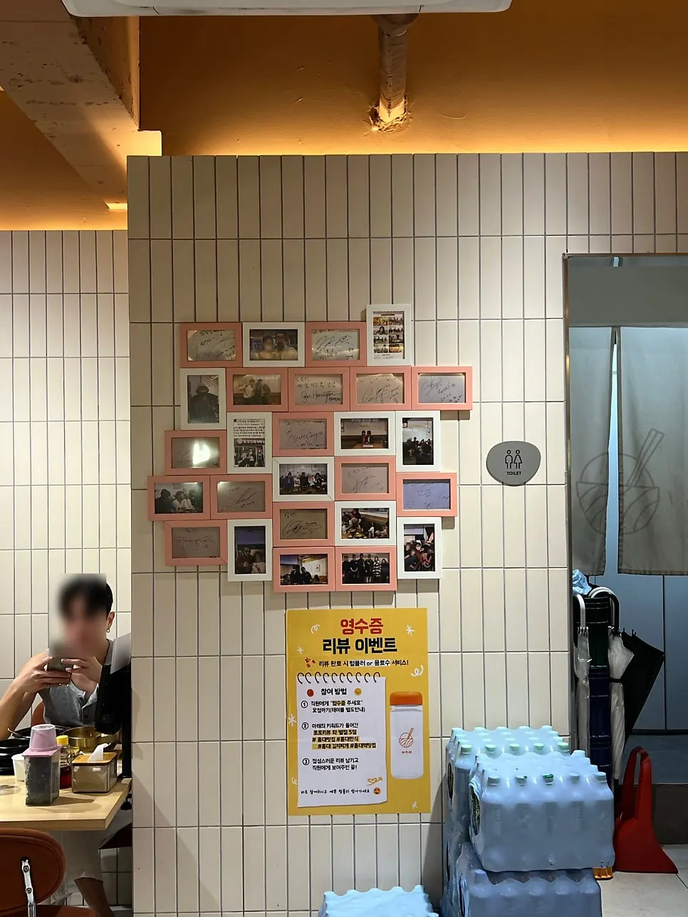 Inner wall decorated with Polaroids and framed signatures